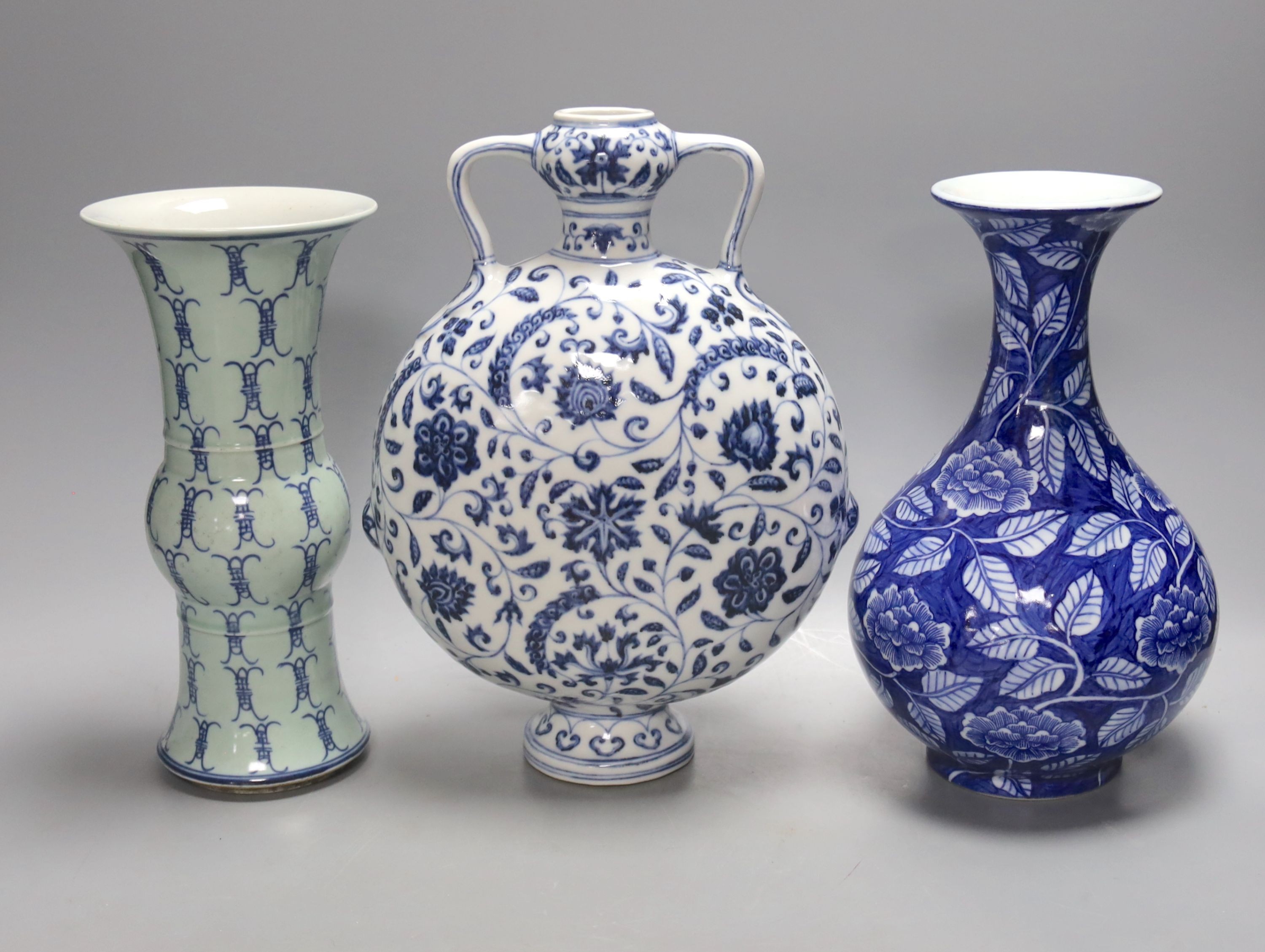 Two Chinese blue and white vases and a similar moon flask, moon flask 28 cms high.